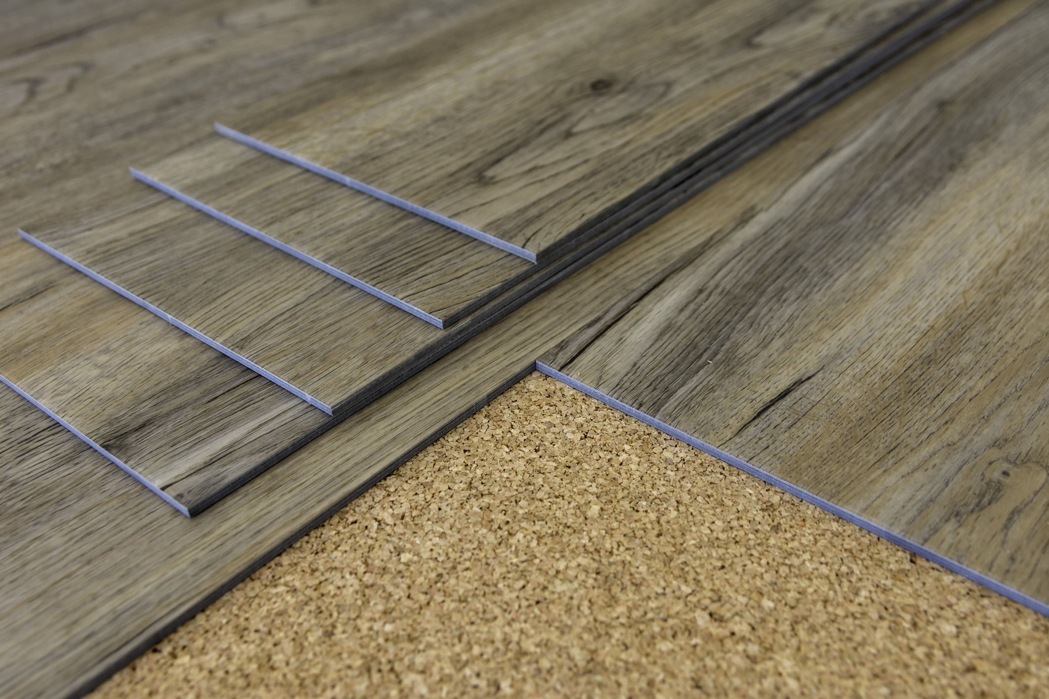 Vinyl plank flooring with light pine wood color, distressed oak graining, and pecan brown sideboards.